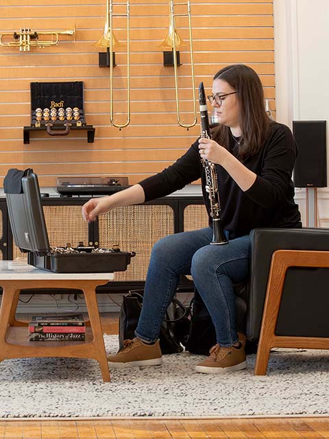 An artist trying out a clarinet.