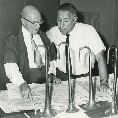 Historic photo of Vincent Bach reviewing a blueprint