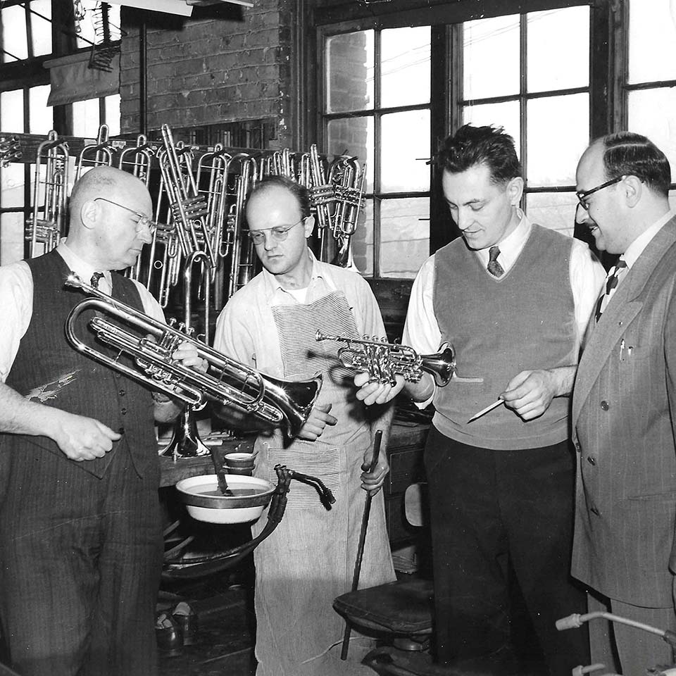 Vincent Bach inspecting a new trumpet