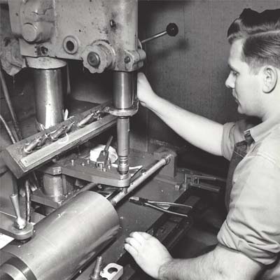 Employee drilling holes for a flute