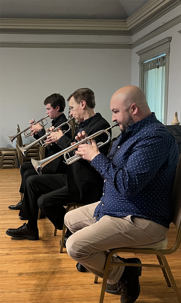Three trumpet performers