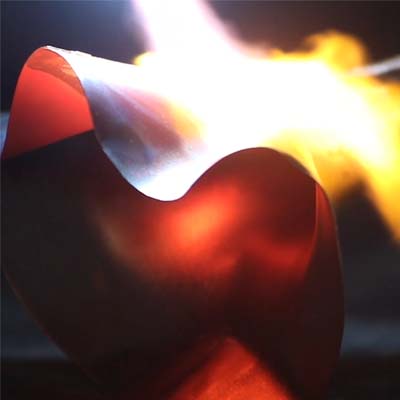 A trumpet bell being heated with fire