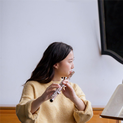 Young woman practicing flute