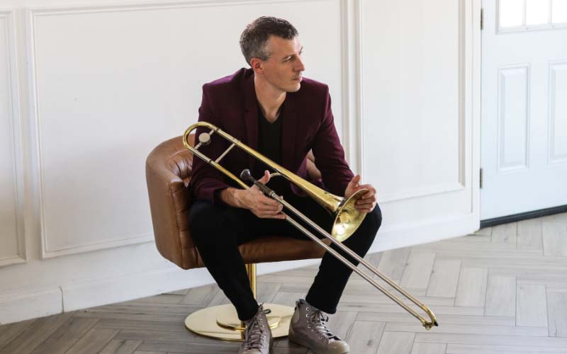 Nick Finzer holding a trombone