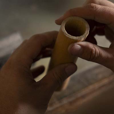 Inspecting a piece of reed wood