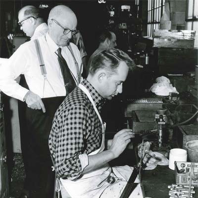 Vincent Bach supervising an employee's work