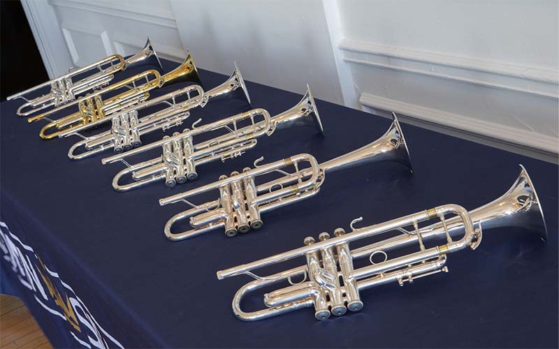 A row of display trumpets on a table