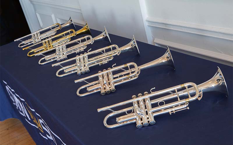 A row of display trumpets on a table